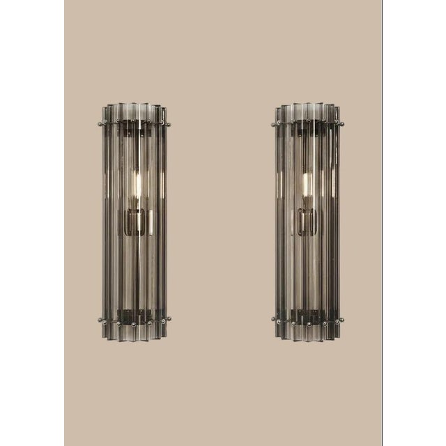 Pair of Murano Wall Sconces | Smoked Triedri Column Model A stunning pair of authentic Murano glass wall sconces, each...