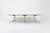 Large wooden table with metal base by Charles & Ray Eames. Wear consistent with age and time. This piece is attributed to...