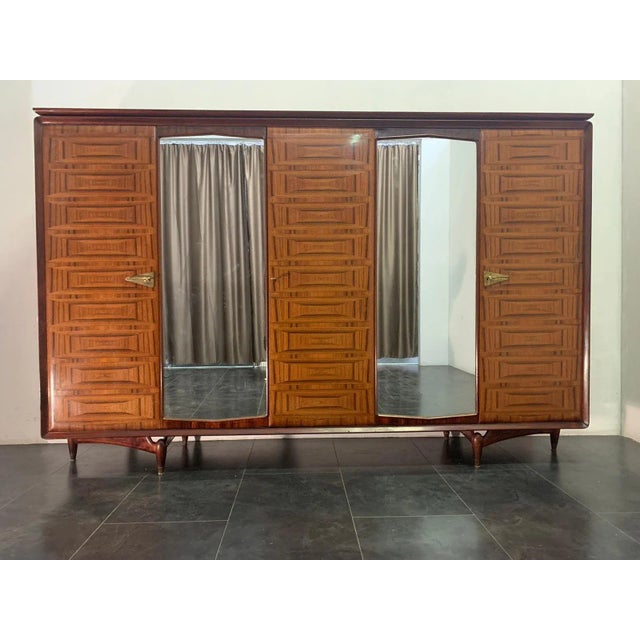 This high-quality cabinet features two mirrors in the center; the doors are curved and finely inlaid with select pau ferro...