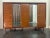 This high-quality cabinet features two mirrors in the center; the doors are curved and finely inlaid with select pau ferro...