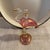 Vintage flamingo pink, clear, gold colored glass perfume bottle with glass stopper. Measures 5.25” high. Lovely piece.