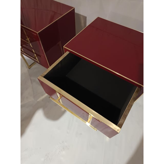 The nightstand, with its Cartier red glass surface, exudes freshness and elegance. Refined brass details extend along the...