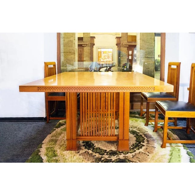 Square table in natural cherry trees with Greek of decoration on the edge of the top, four legs with strips. Chairs with...