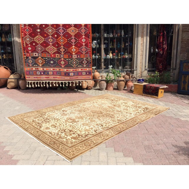 One-of-a-kind vintage rug, hand-knotted in Isparta, Turkey A series of repeating medallions fill out the field in...