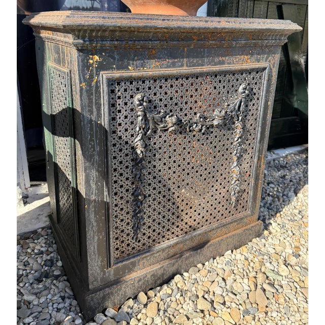 Antique cast-iron radiator surround, circa 1900, featuring beautiful ornamentation and original patina. Fitted with a...