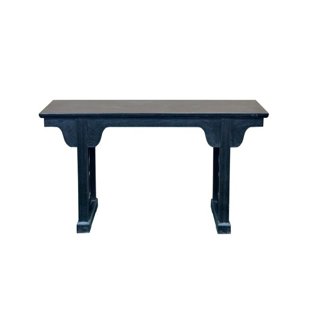 This elegant, minimalist console table features a deep, charcoal-black finish that beautifully highlights the subtle,...
