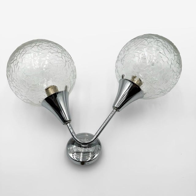 Here is a pair of Space Age wall sconces, circa 1970, emblematic of the futuristic aesthetic that characterized European...