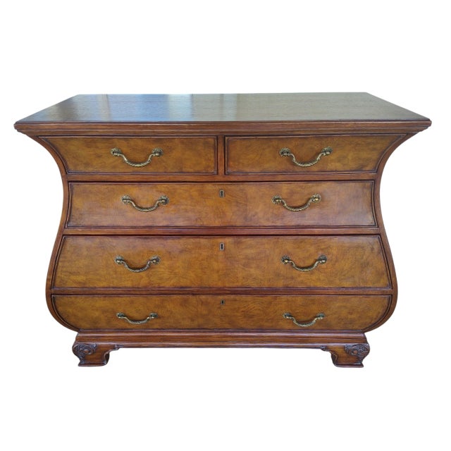 Elegant Townhouse Collection Bombe chest, model 30-9464. This stunning piece features beautiful burl wood drawer fronts...