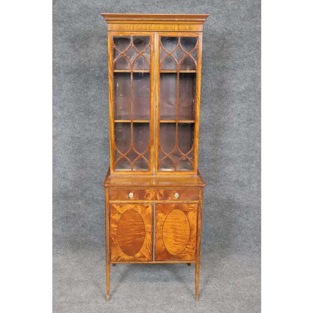 An exquisite example of late Victorian craftsmanship, this narrow English curio cabinet is constructed from high-quality...