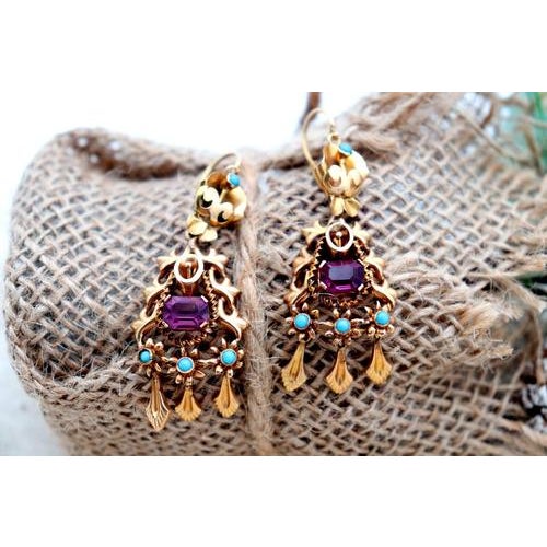 Gold earrings with reliefs and cutouts, calibrated amethyst applications in the center, turquoise and three tilting...