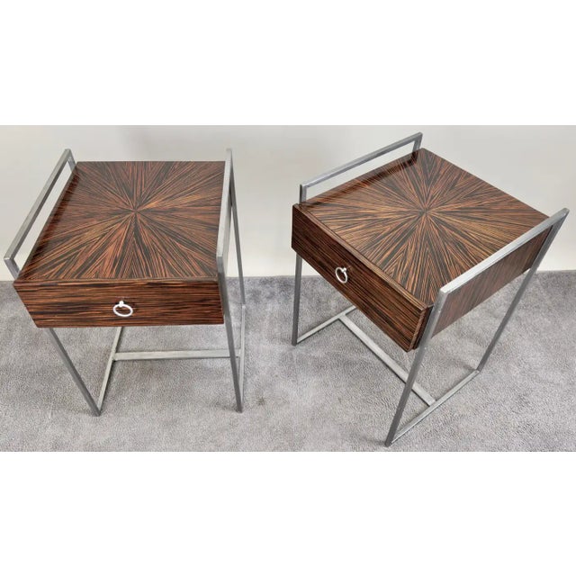 A pair of Mid-Century Modern nightstands or end tables showcases a striking blend of minimalist design and exotic...