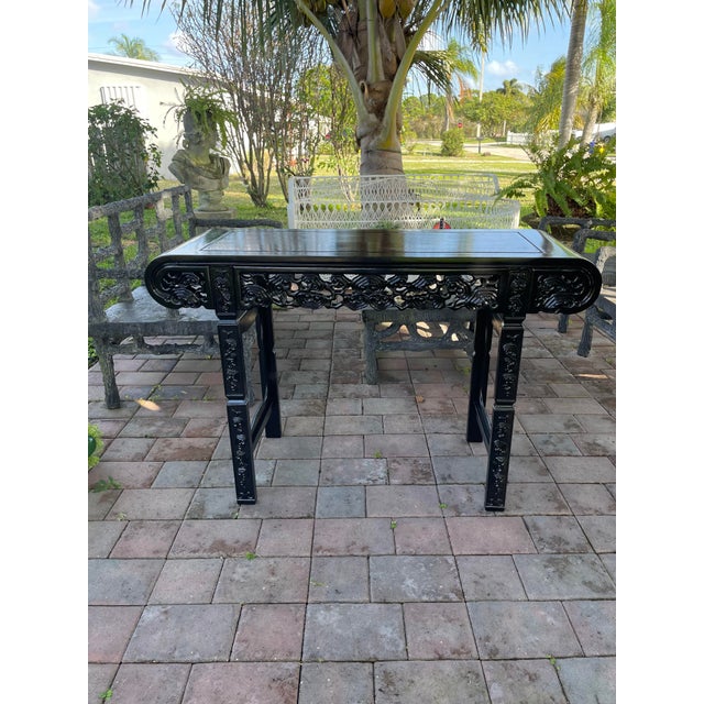 Chinese Black Lacquered Mahogany Console Table This elegant Chinese console table is crafted from solid mahogany and...