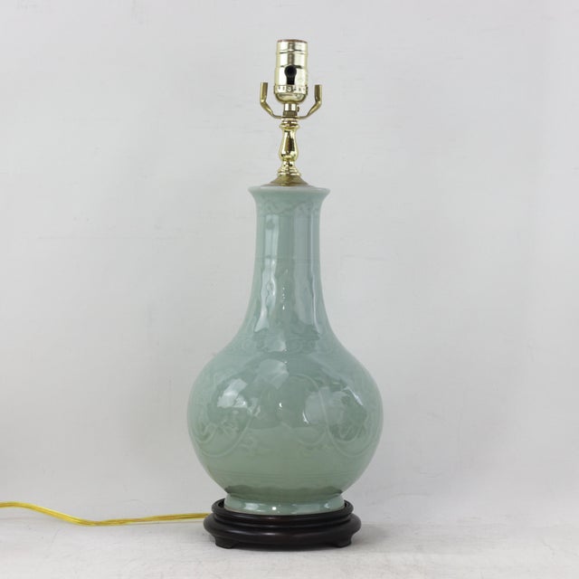 This exquisite pair of vintage table lamps features a classic bottle-shaped silhouette crafted from fine pale green...