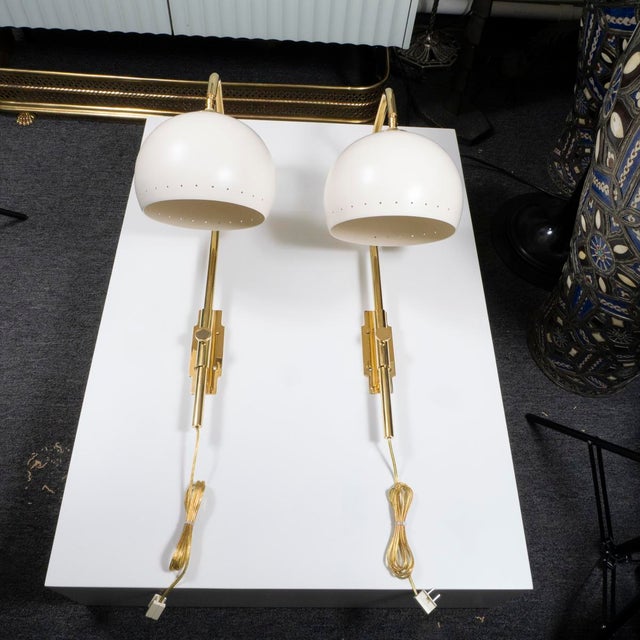 Pair of mid-century style articulated sconces with dome shades.