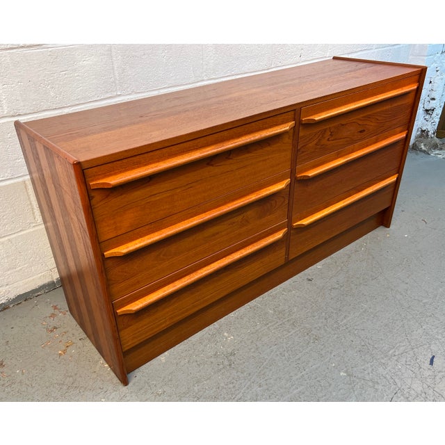 A beautiful example of classic Danish modern design, this vintage six-drawer teak dresser showcases the clean lines,...