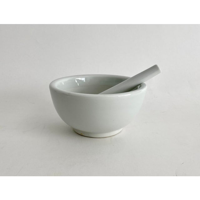 This heavy white ironstone mortal and pestle is functional and beautiful for its clean lines.