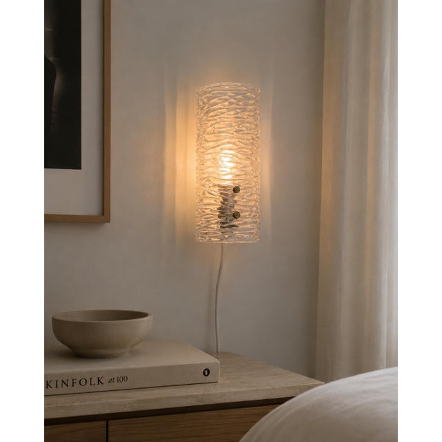 When lit, the rippling ice relief surface of this cylindrical glass shade scatters light in all directions — every...