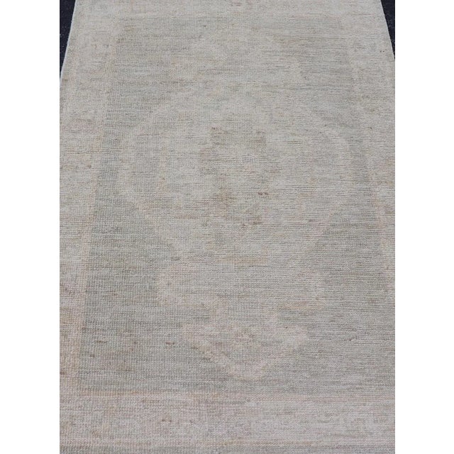 Modern Oushak with Off Gray Background with A Large Tribal Medallion in Cream. Country of Origin: Afghanistan; Type:...