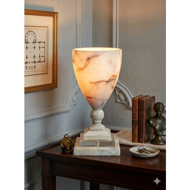 This elegant neoclassical table lamp is crafted from richly veined white alabaster mounted on a clear lucite base,...