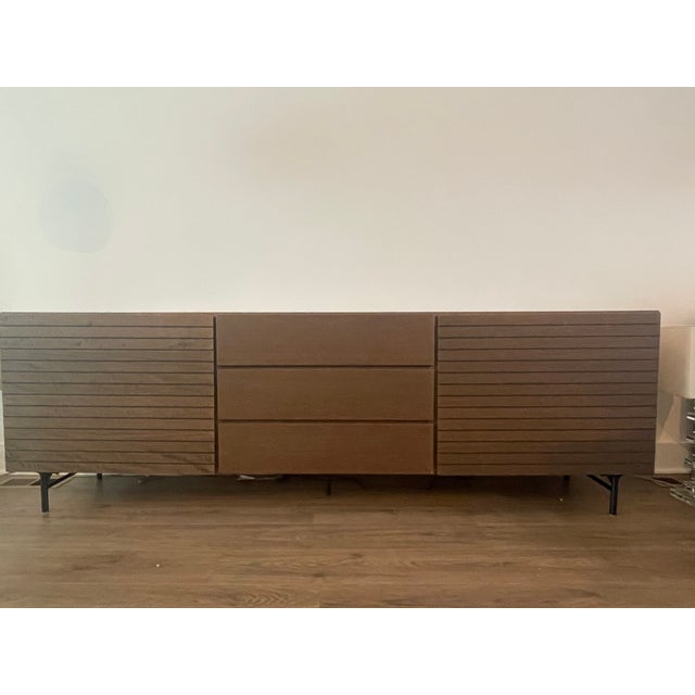 BoConcept Sideboard Dimensions: 90 3/4" W x 19 " D x 29" H Material: Dark Oak Veneer Legs: Matt Black Structured Lacquered...