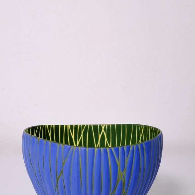 Beautiful two-tone glass vase in opaque green and blue, blown and handcrafted, then glazed and engraved. Philip Baldwin;...