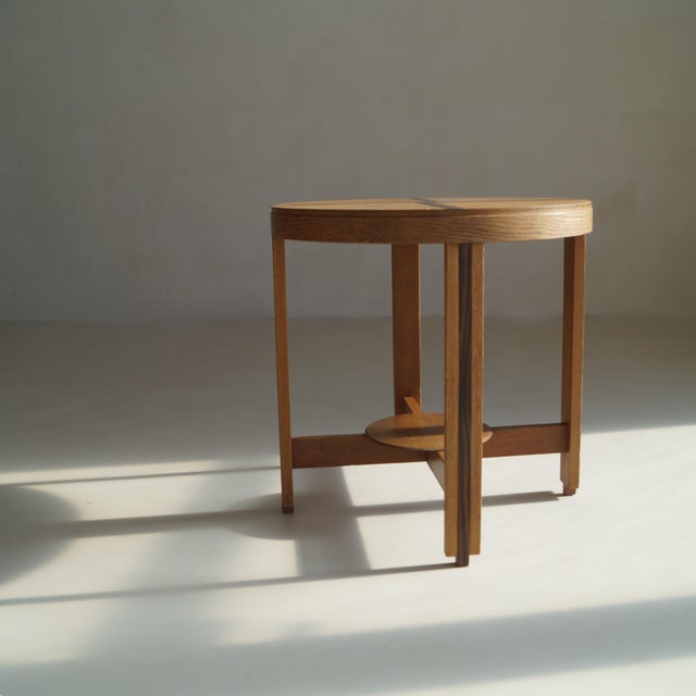 A refined Dutch Art Deco side table from the 1920s, executed in solid oak and oak veneer with macassar ebony (coromandel)...