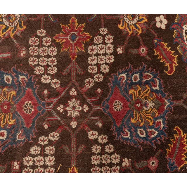 An early 20th century Indian Agra antique rug, the black field with a bold polychrome trellis of palmettes, restrained...