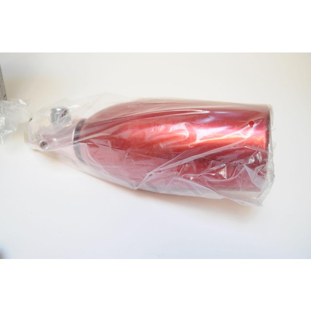 Unused in box red anodized aluminum syphon/seltzer bottle manufactured by Gimas for Martini and Rossi (ca. 1970s, Italy)....