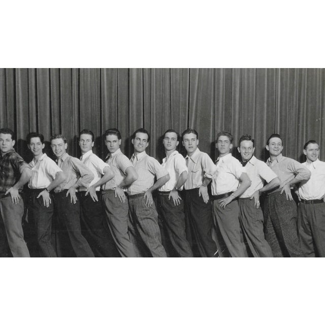1950s black and white photograph of a male dance or acting troupe from Ann Arbor Michigan. Bearing the studio mark of Dey...