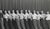 1950s black and white photograph of a male dance or acting troupe from Ann Arbor Michigan. Bearing the studio mark of Dey...