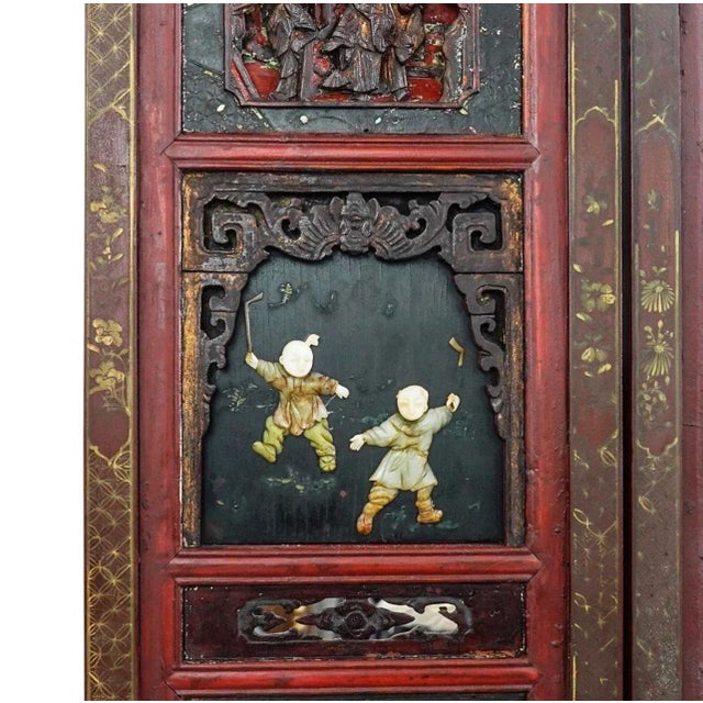 Five panel Qing dynasty screen, each panel of which features several lacquered wooden tiles decorated with imagery either...