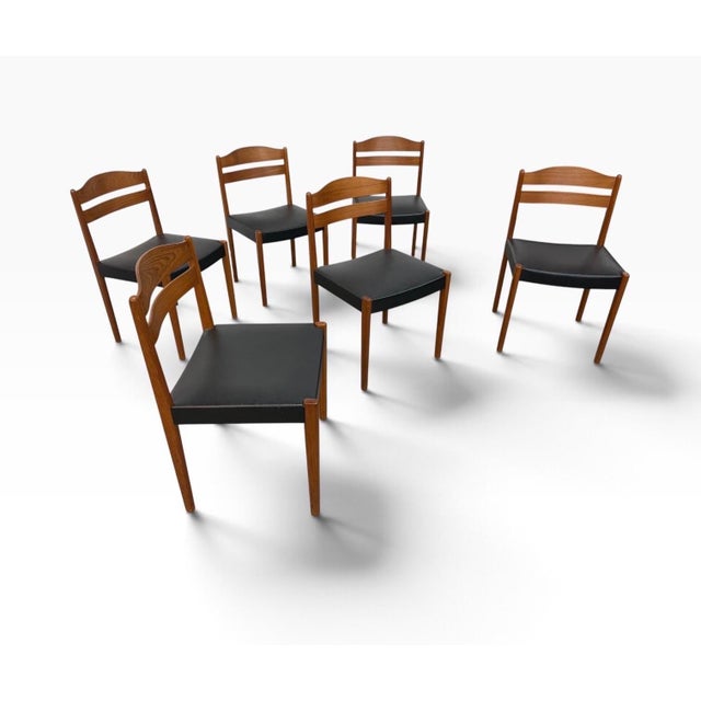 A handsome set of six Mid-Century Danish Modern teak dining chairs, circa 1960s, featuring classic Scandinavian...