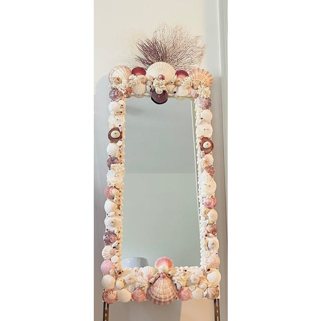 Fabulous white and pink sea shells encrusted 4 ft tall wall mirror. Decorated with 3 branches of sea whip on top.