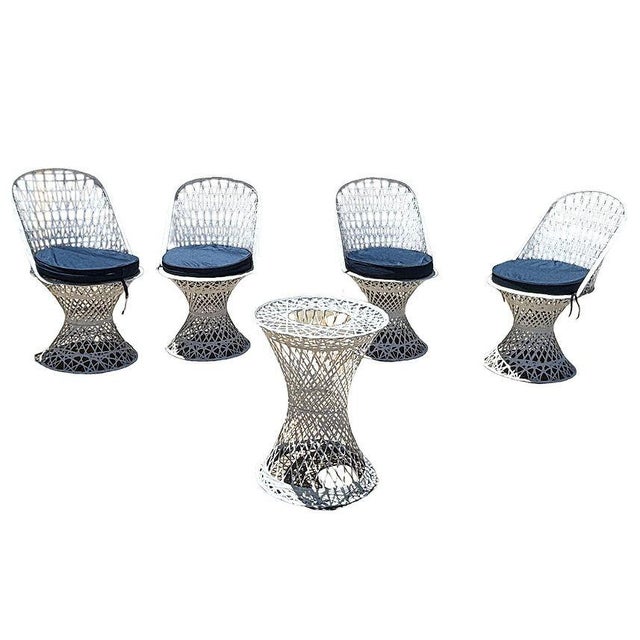 Set of four Mid-Century Modern spun fiberglass dining chairs with a matching pedestal table in the style of Russell...