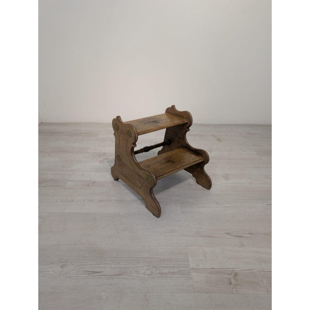 An original wooden step stool with a decorative, stylized design. The piece features two levels and attractively contoured...