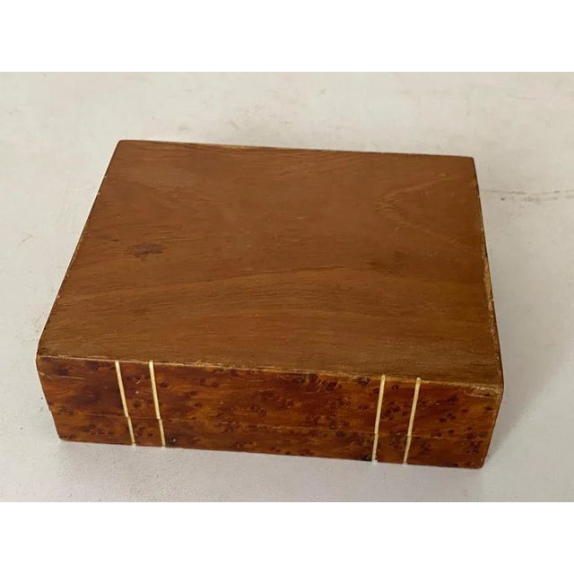 This box is in burl wood. It has been made in France in the 1870s. The color is brown, and it is in an good condition....