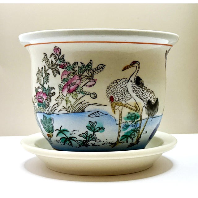 Vintage Chinese porcelain planter with its original matching tray, featuring an elegant hand‑painted crane scene...