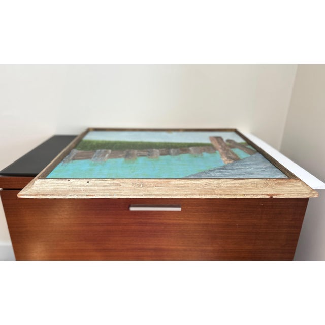 Signed oil painting titled Bulkhead Canal, dated 1970 on verso. Cindy Auerbach is a contemporary American painter whose...