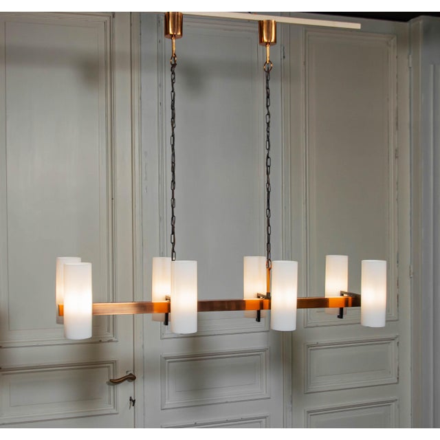 Beautiful 1970s horizontal copper chandelier attributed to Jo Hammerborg for Fog & Mørup Denmark. The eight glass shades...