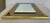 1970s rectangular mirror with smoke glass border and brass frame. May be hung vertically or horizontally.