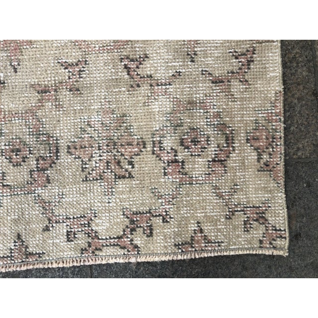 This is a vintage Turkish Oushak rug from the 1960s. The piece was hand-knotted.