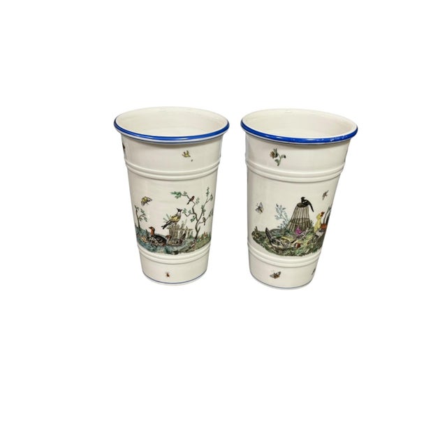 A beautifully decorative near pair of early 19th-century berlin porcelain jardinieres, each finely hand-painted with...