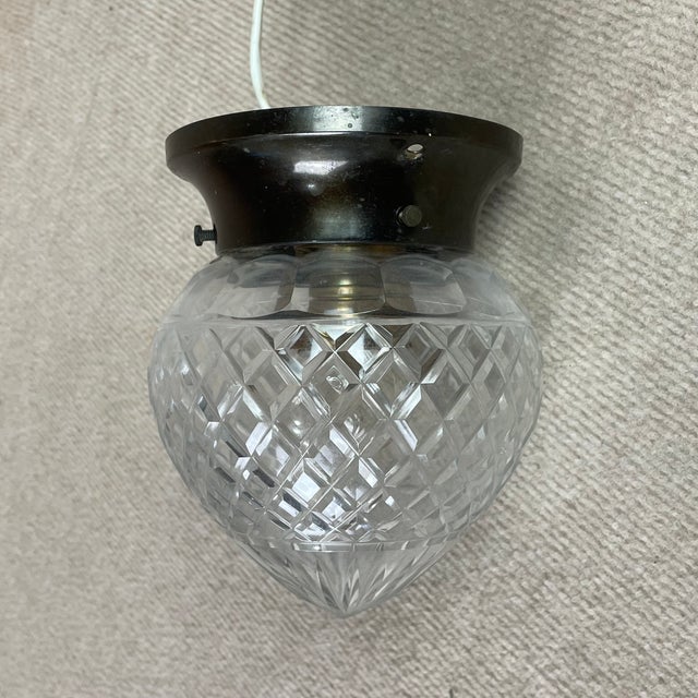 Small Art Nouveau ceiling lamp in patinated brass and cut crystal glass. Up to 250V (Europe/UK Standard).The wiring of...