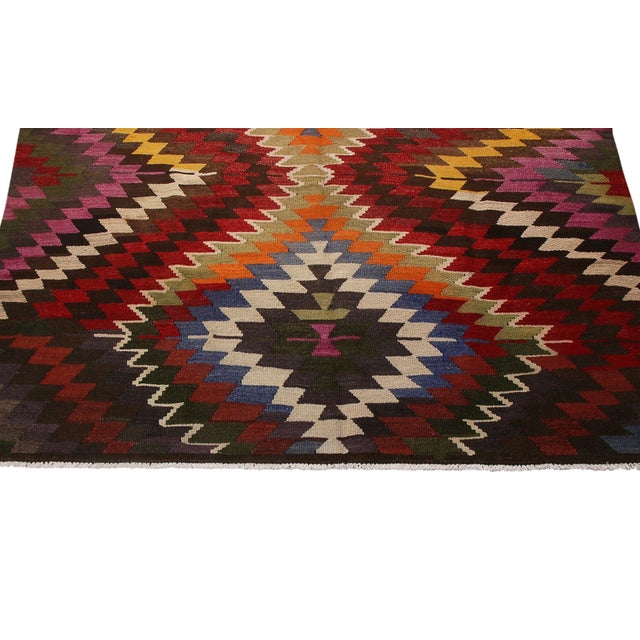 Flat woven in Turkey originating between 1950-1960, this vintage mid-century tribal kilim hails from the town of Mut,...