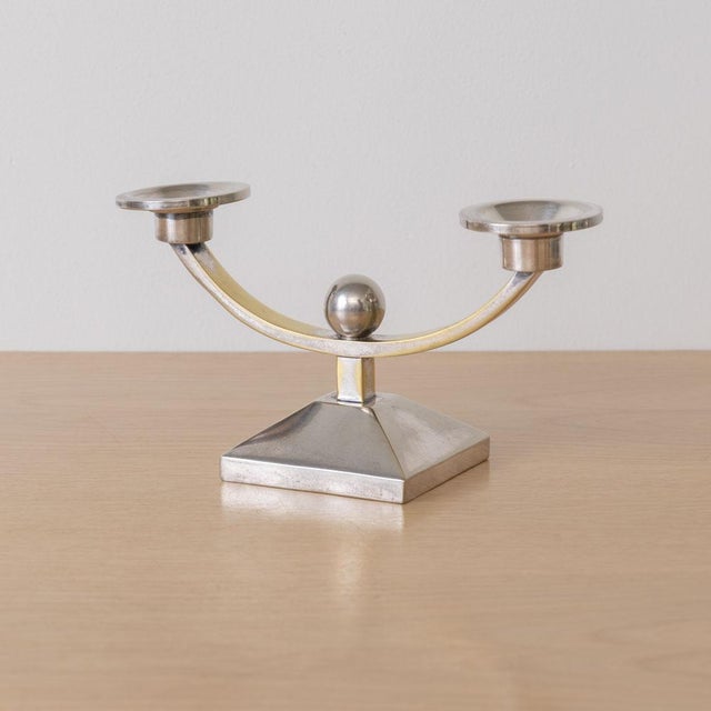 Stunning pair of Art Deco candleholders from France, 1930s. Beautiful silver-plated brass form with curved arms and ball...