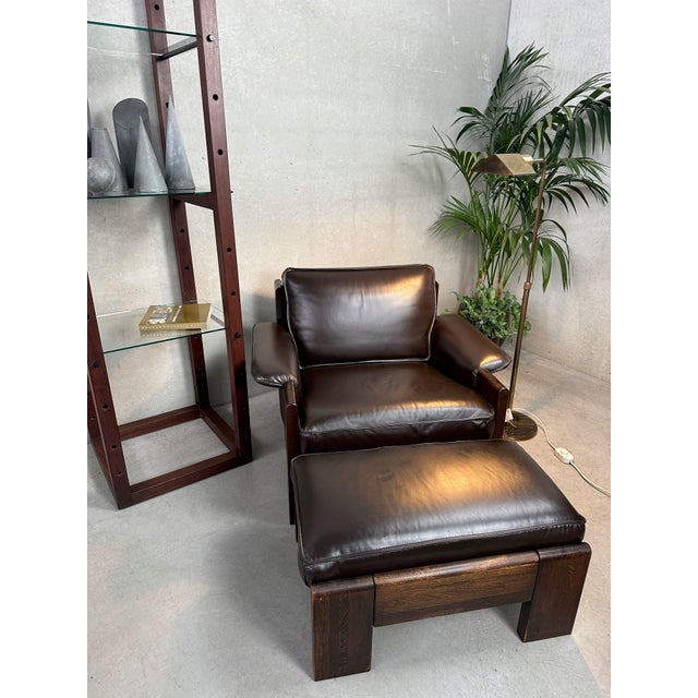 Vintage midcentury lounge set (armchair and ottoman) in dark brown leather by Harry De Groot for Leolux in the 1970s....
