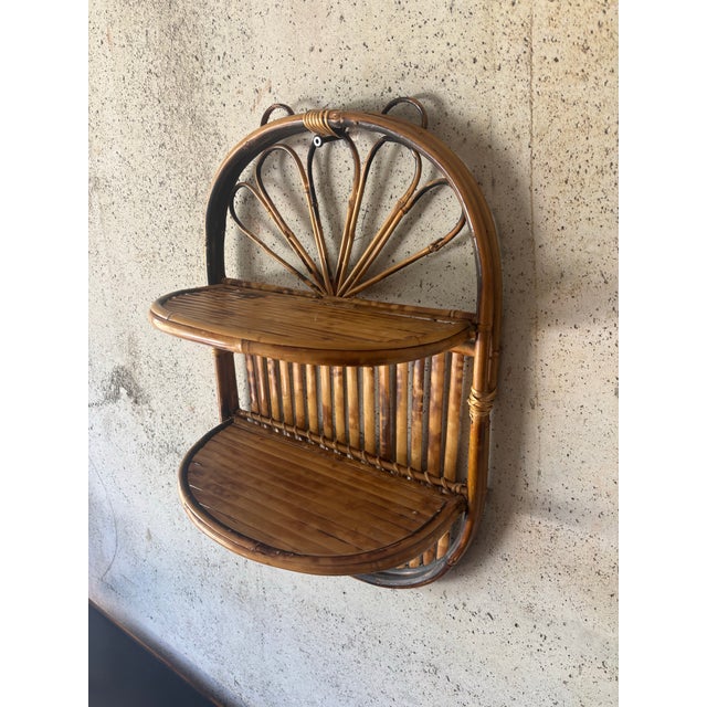 Charming vintage wall-mounted shelf handcrafted from burnt bamboo with two folding semicircular shelves. Features a...