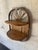 Charming vintage wall-mounted shelf handcrafted from burnt bamboo with two folding semicircular shelves. Features a...