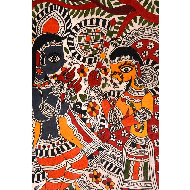 Celebrate the timeless love of Radha and Krishna through this beautiful hand-painted Madhubani artwork by Mamta Devi,...