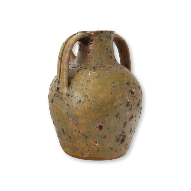 Late 19th century French glazed terracotta olive oil jug with a rounded provincial form and two generous loop handles...